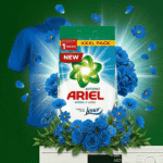 Box of Ariel automatic laundry detergent with a blue shirt in the background, showing the 'New' label and 'XXXL PACK' at the top surrounded by blue flowers.